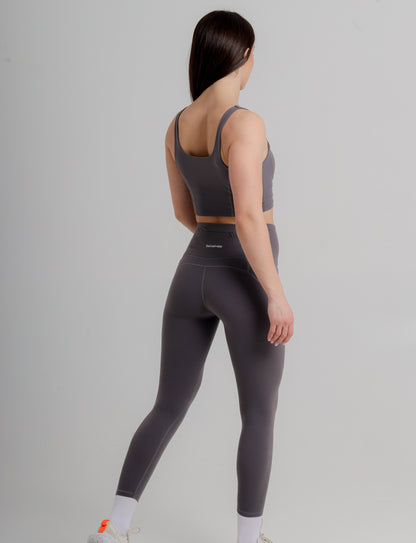 Elegant model wearing the Active Grey Sports Bra from Incl.usiveinc, ideal for diverse workout activities, highlighting its comfort and high-performance style.