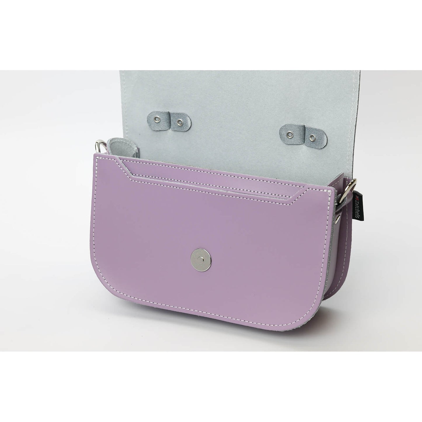 Spacious interior of Aura Pastel Violet Leather Handbag by Zatchels, featuring a secure magnetic fastener and a cute carry handle, designed for modern elegance.