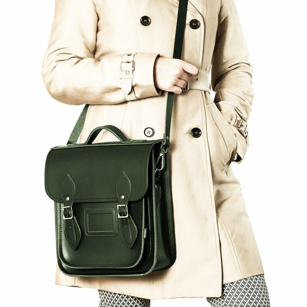 Chic and compact Handmade Ivy Green Leather City Backpack set against a stylish urban backdrop, perfect for tablets and laptops.
