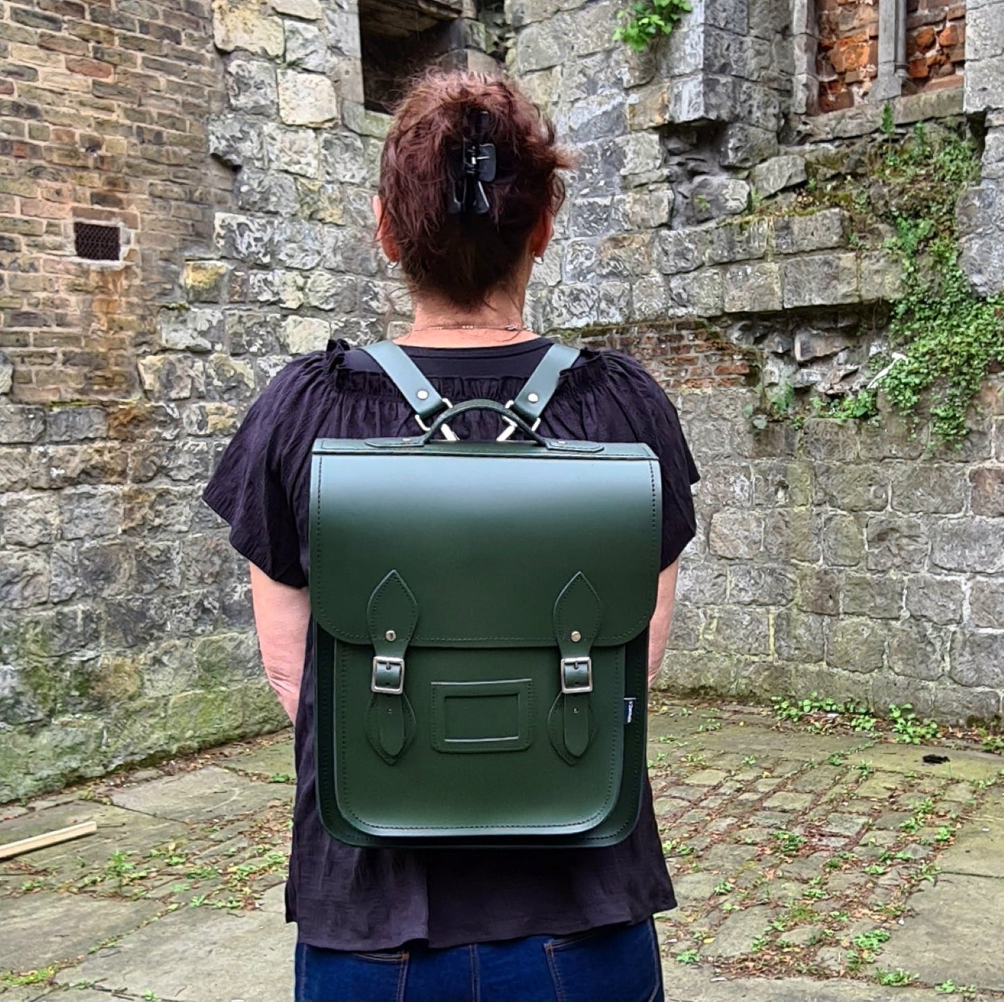 Versatile Handmade Ivy Green Leather City Backpack styled as a shoulder bag, perfect for transitioning from day to night.