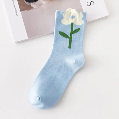 Luxurious Women's Tie-Dye Middle Tube Socks adorned with a soft blue background and white flower embellishment for an understated yet fashionable appeal.