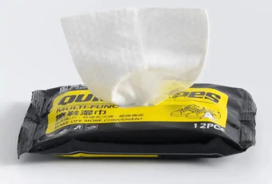 A pack of Quick Shoe Wipes prominently displayed, highlighting its sleek black and yellow design, ideal for meticulous shoe care.