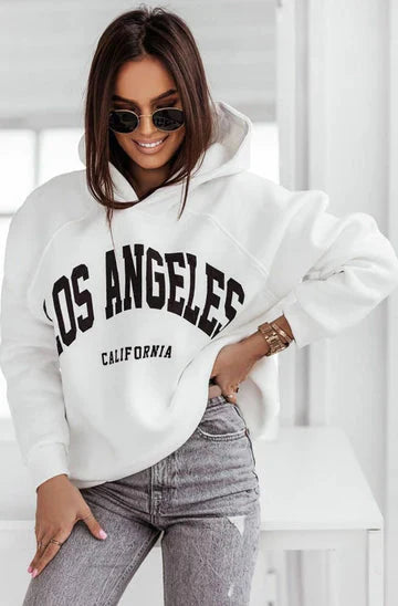 Elegant display of the oversized hoodie in white, emphasising soft fleece fabric and casual street-style appeal.