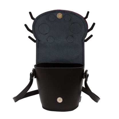 Stylish Luna Ladybird Handmade Leather Barrel Bag shown in a chic outdoor setting, demonstrating its versatility as a fashionable accessory for any occasion.