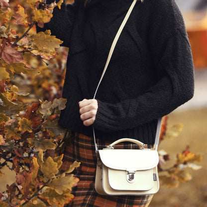 Close-up view of the Luna Cream Leather Bag's secure push lock clasp and detachable strap, highlighting its premium quality and stylish functionality.