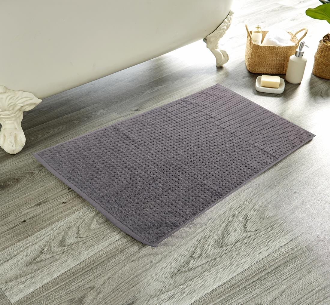 OLIVIA ROCCO Luxe Deep Cotton Pile Bathmat in a contemporary bathroom setting, demonstrating its quick-drying features and sustainable design while complementing luxury decor.