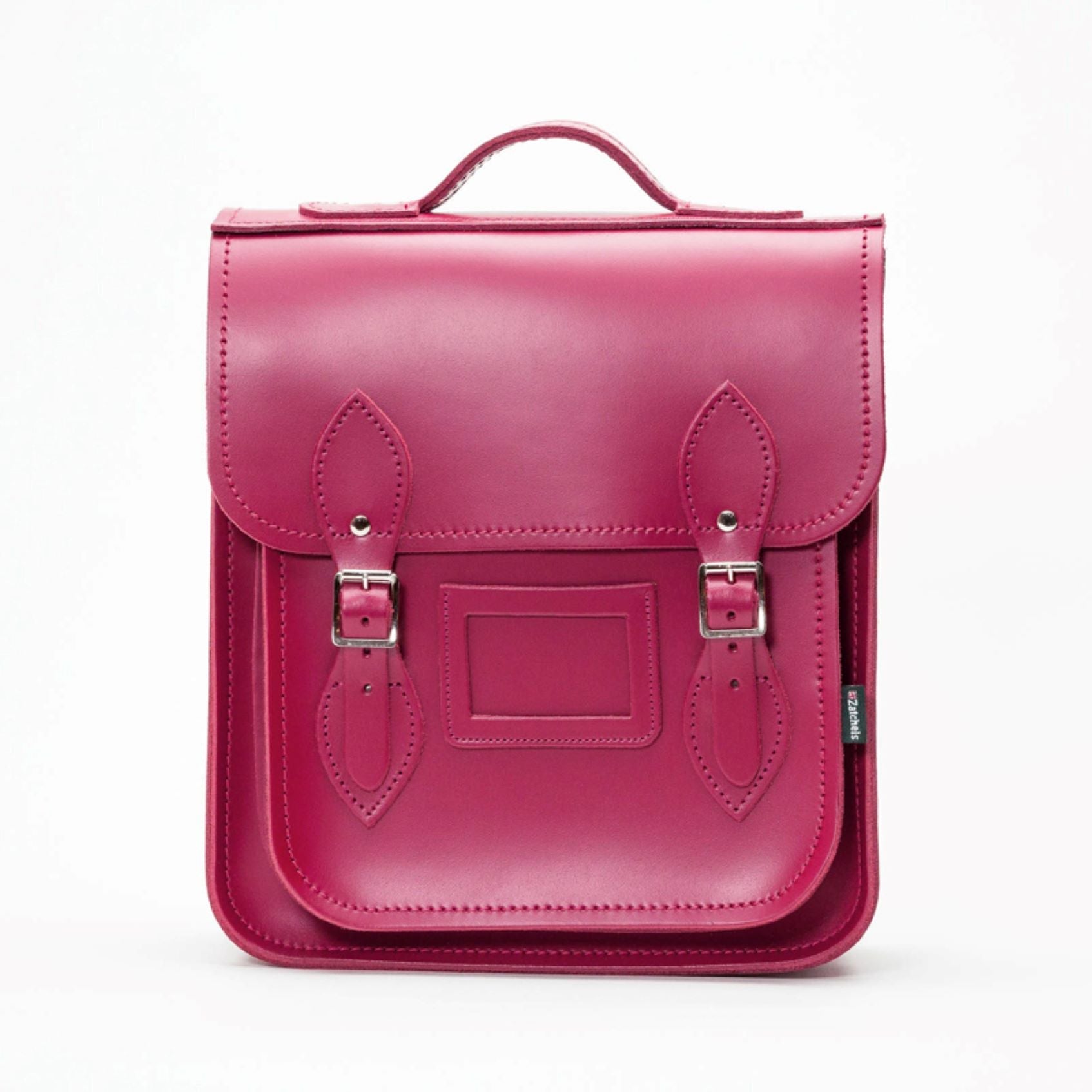 Premium handmade leather city backpack in vibrant magenta, showcasing exquisite British craftsmanship with signature cable stitching and silver nickel buckles, ideal for stylish urban adventures.