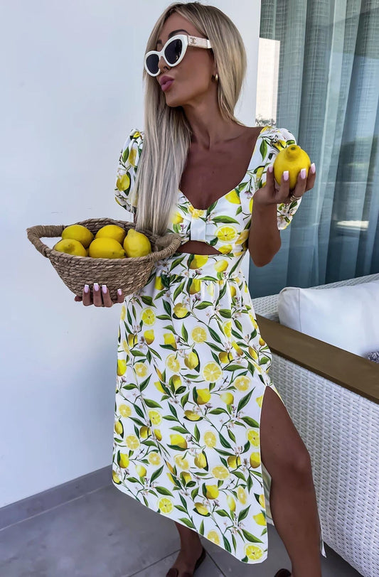 Elegant Zesty Lemon Printed Cut-Out Midi Dress with Puff Sleeves, crafted in Italy, showcasing a low-cut neckline, padded bust, and breathable side slits for a chic summer look, available in sizes S-L.