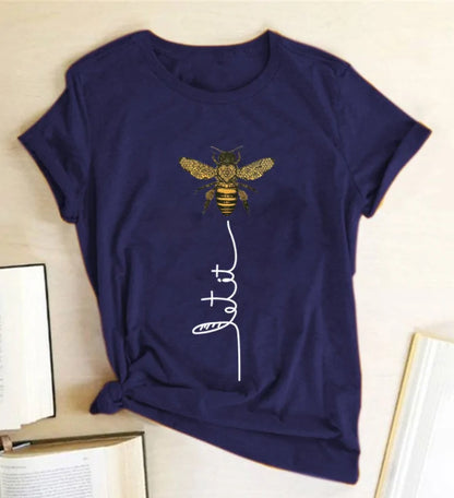 Dazzling Dreams Studio's Bee Kind Women's Graphic Tee displayed elegantly on a hanger, perfect for summer styling and casual outings.