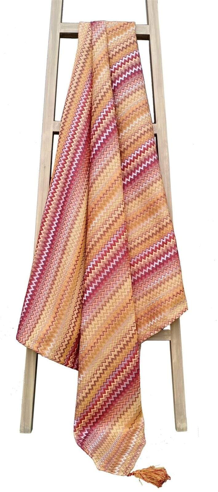 The Mia Bohemian Throw Blanket adorned with detailed tassels, showcasing its stylish bohemian pattern, ideal for adding warmth and elegance to any living space.