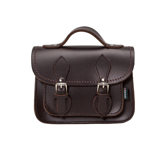 Handmade dark brown leather micro satchel with adjustable crossbody strap and nickel silver fastenings, showcasing exquisite craftsmanship and luxurious design.