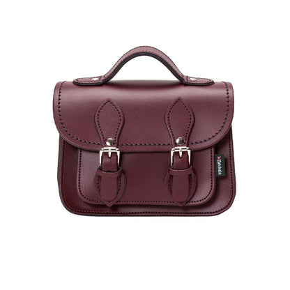 Handmade Marsala Red Leather Micro Satchel showcasing premium craftsmanship with intricate matching stitching and nickel silver buckles.