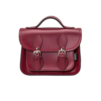 Handmade Oxblood Leather Micro Satchel with adjustable and detachable strap, showcasing luxurious craftsmanship and elegant design, ideal for both casual and formal occasions.