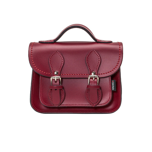 Handmade Oxblood Leather Micro Satchel with adjustable and detachable strap, showcasing luxurious craftsmanship and elegant design, ideal for both casual and formal occasions.