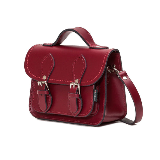 Luxurious handmade oxblood leather micro satchel showcasing its elegant craftsmanship and rich texture, perfect for stylish occasions.