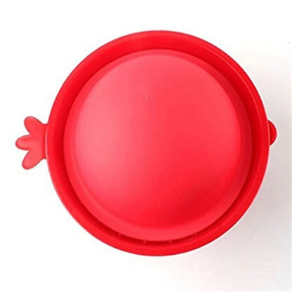 Top view of a sleek red pomegranate seed tool, artfully shaped for easy handling and perfect for enjoying this luxurious fruit without the fuss.