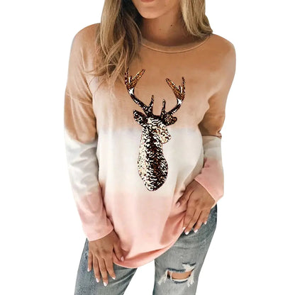 Stylish women's reindeer sweater in a delicate peach gradient, with sparkling sequins, perfect for festive gatherings and winter outings.