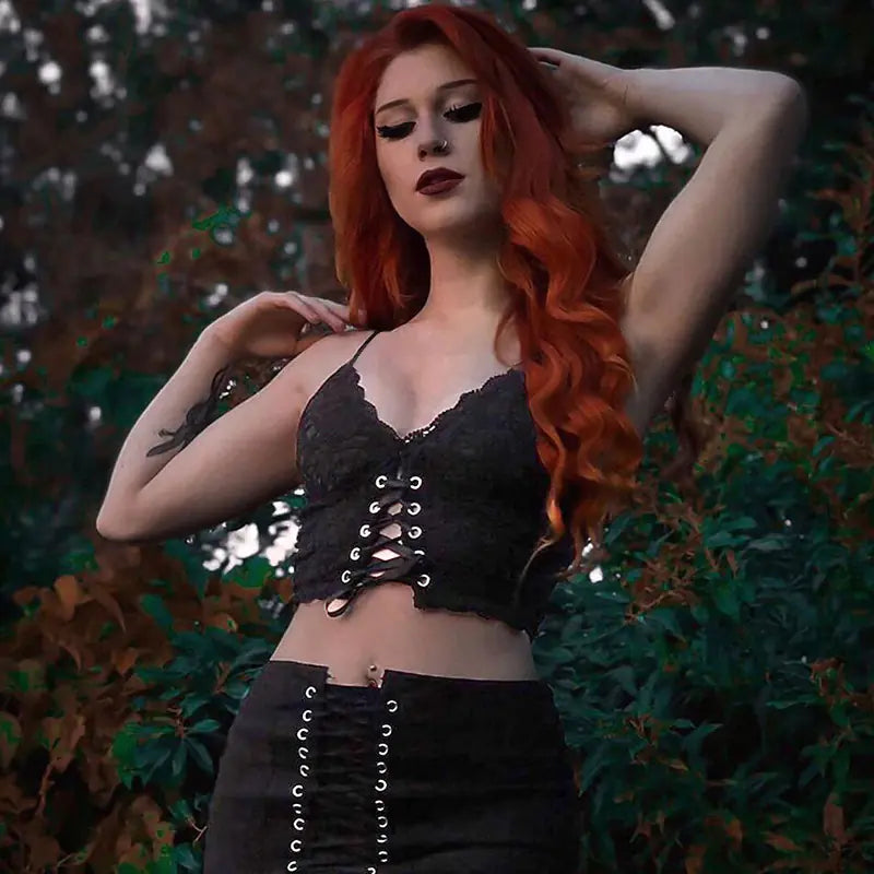 Chic black lace tank top displayed by a model against a natural backdrop, highlighting its luxurious lace and fit.