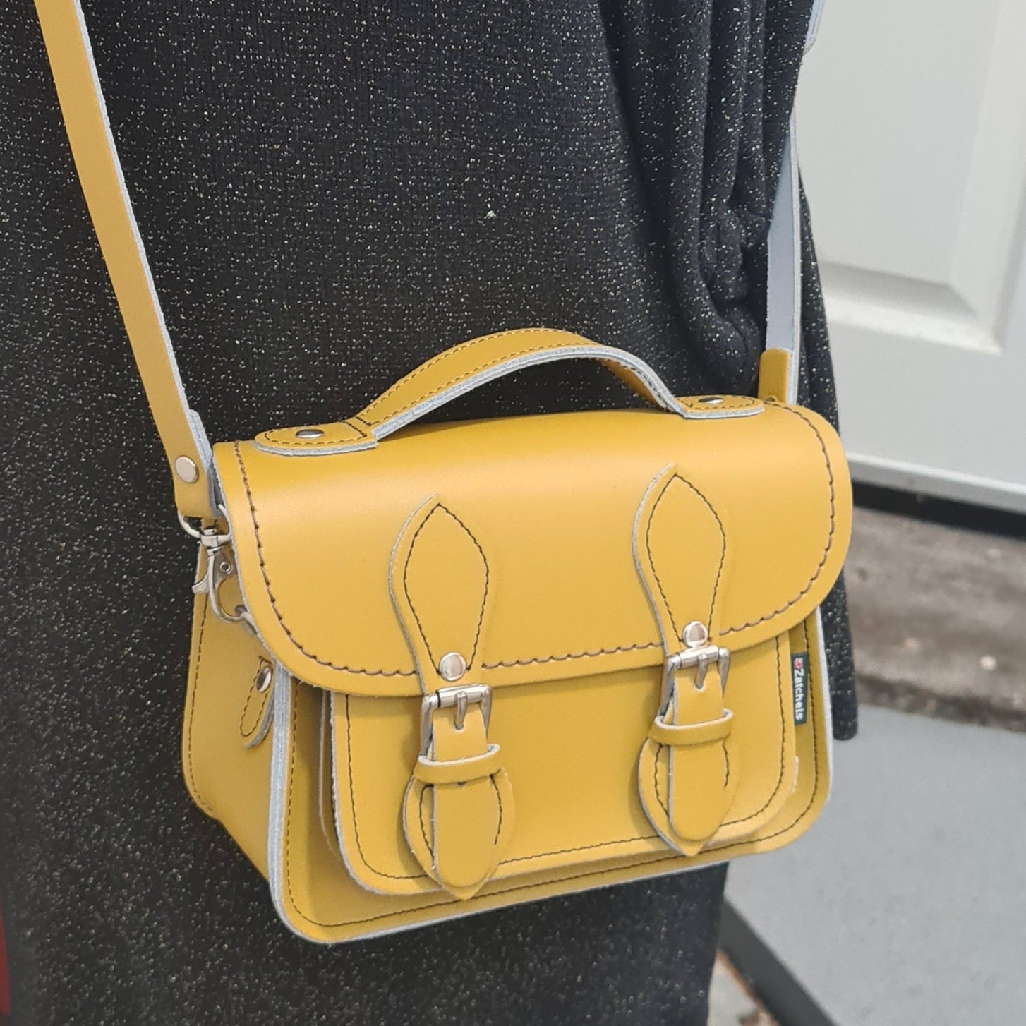 Handmade Yellow Ochre Leather Micro Satchel by Zatchels displayed elegantly, showcasing its luxurious craftsmanship and adjustable, detachable strap for versatile styling.