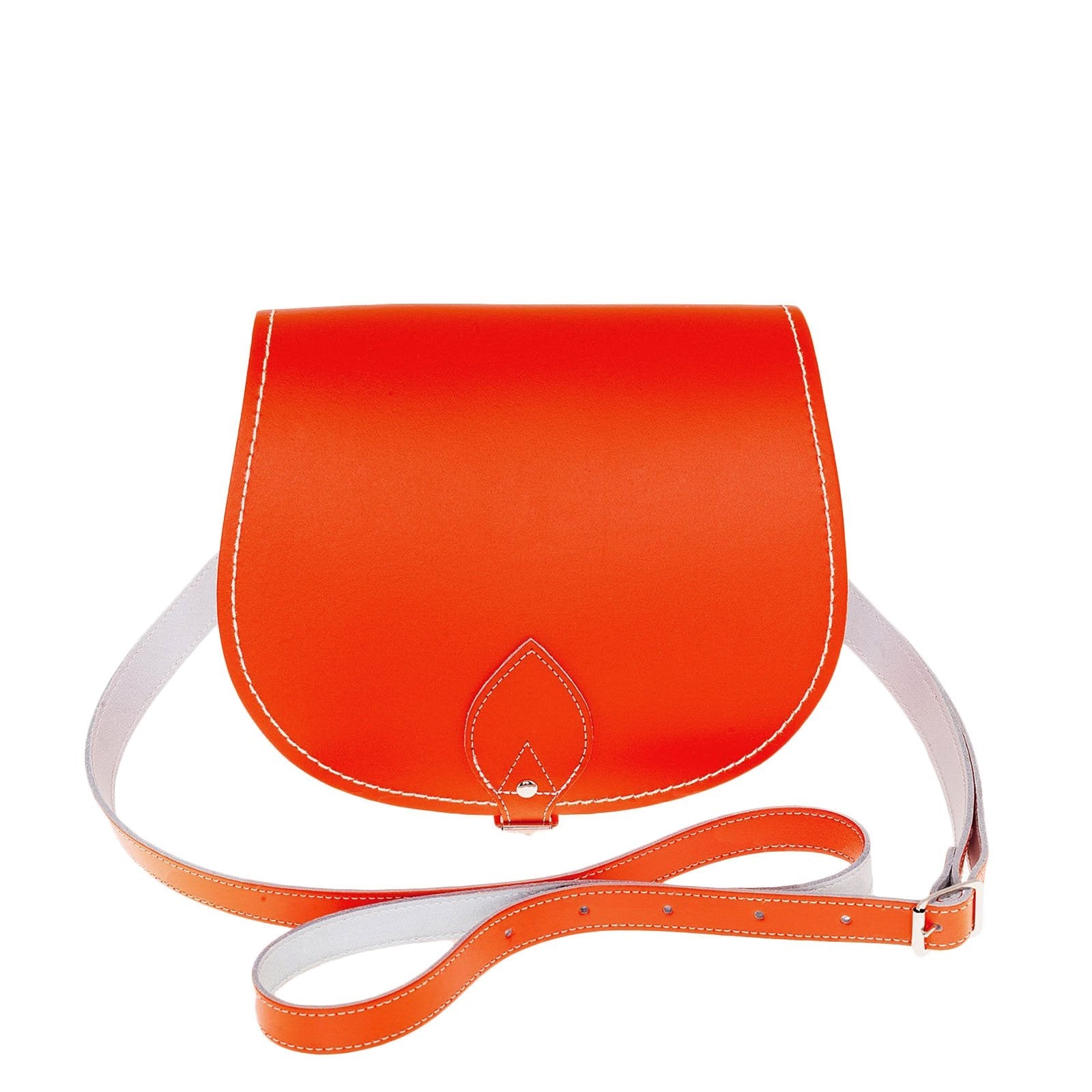 Luxurious handmade orange leather saddle bag with adjustable crossbody strap and oversized flap, showcasing traditional craftsmanship and modern style, ideal for daily use and available in two sizes.