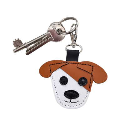 Elegant leather dog bag charm in burnt orange, featuring distinctive handstitched quality and embossed logo from Zatchels, perfect as a chic accessory or gift for dog lovers.