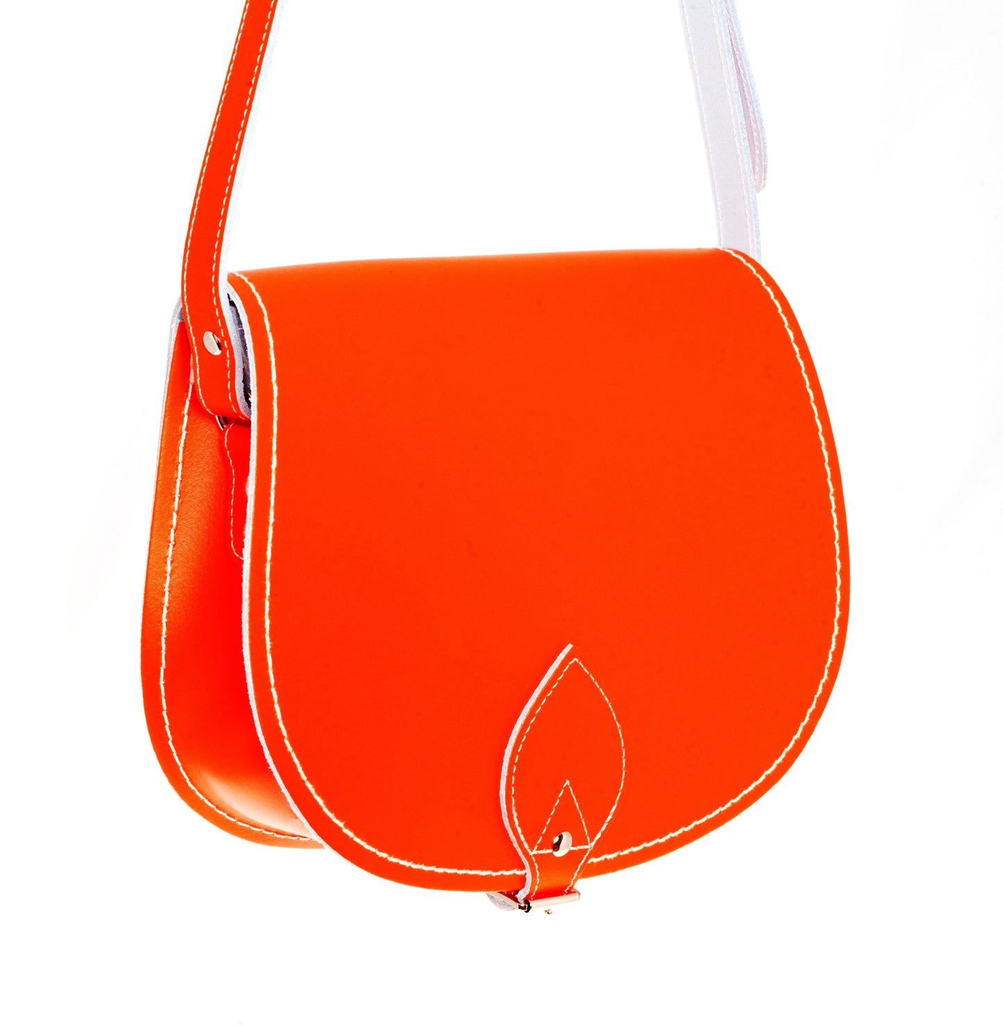 Luxury Handmade Leather Saddle Bag in vibrant orange, showcasing its exquisite craftsmanship and oversized flap design.