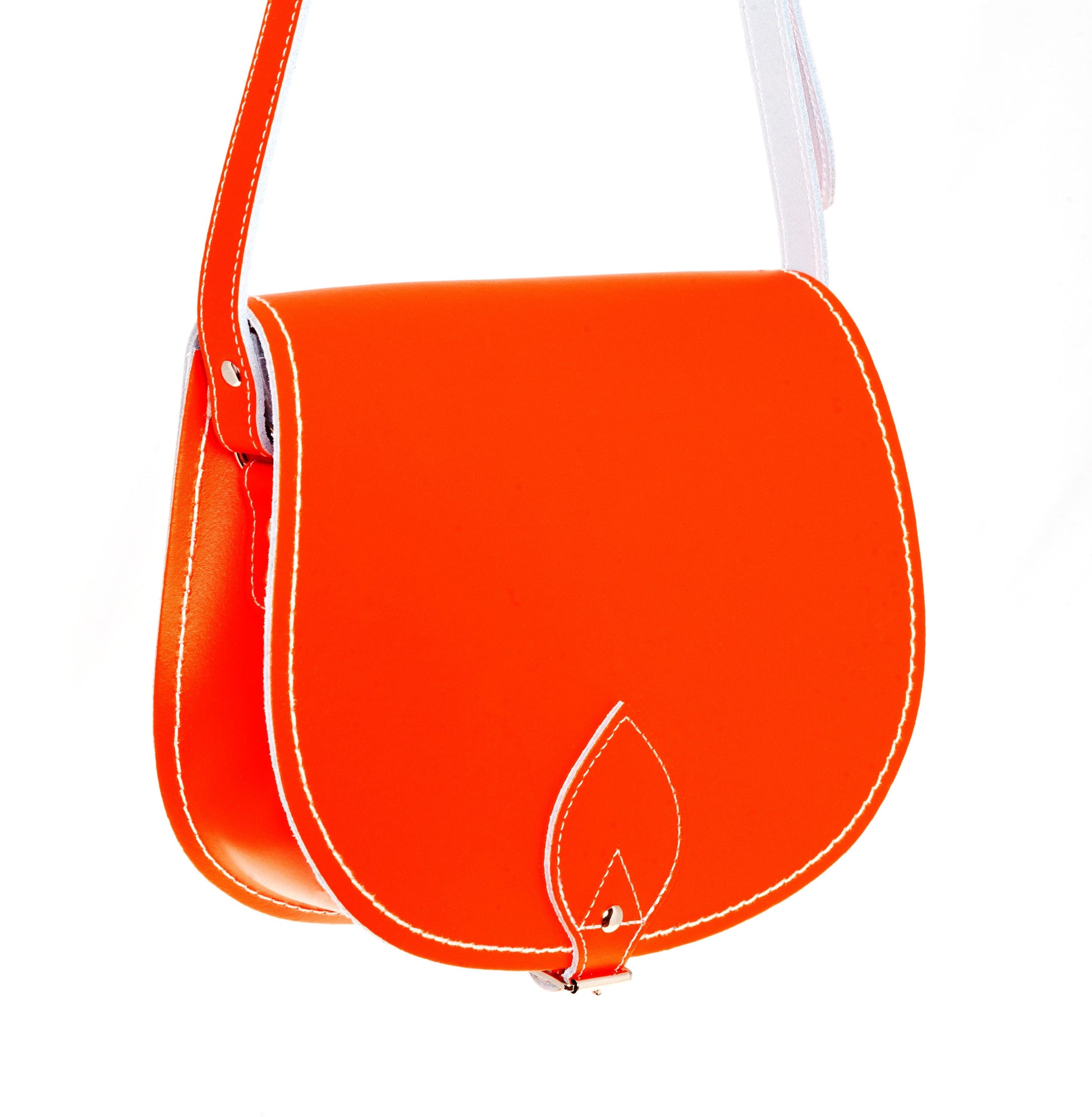 Luxury Handmade Leather Saddle Bag in vibrant orange, showcasing its exquisite craftsmanship and oversized flap design.