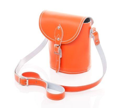 Interior view of the handmade orange leather barrel bag by Zatchels, displaying spacious compartment and elegant craftsmanship for stylish organisation.