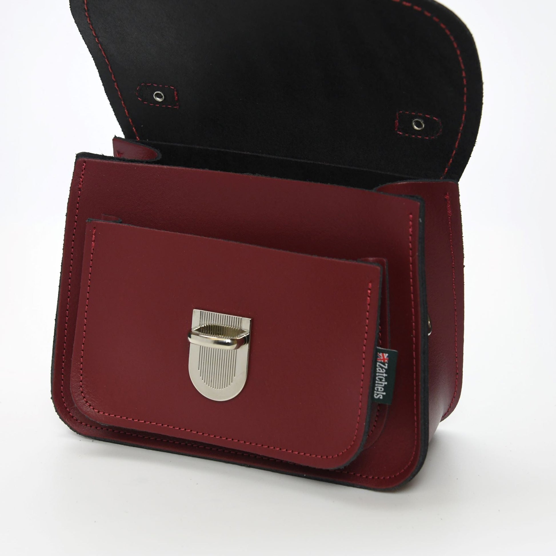 Elegant push-lock clasp detail of the Luna Handmade Oxblood Red Leather Bag, emphasizing security and sleek design.