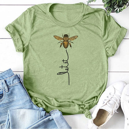 Bee Kind Women's Graphic Tee by Dazzling Dreams Studio displayed on a hanger - Highlighting the breathable cotton blend fabric ideal for warm weather.