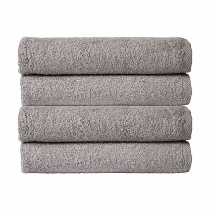 Four neatly folded large quick-drying cotton bath sheets in an elegant array of colours, perfect for home or travel, highlighting their easycare features.
