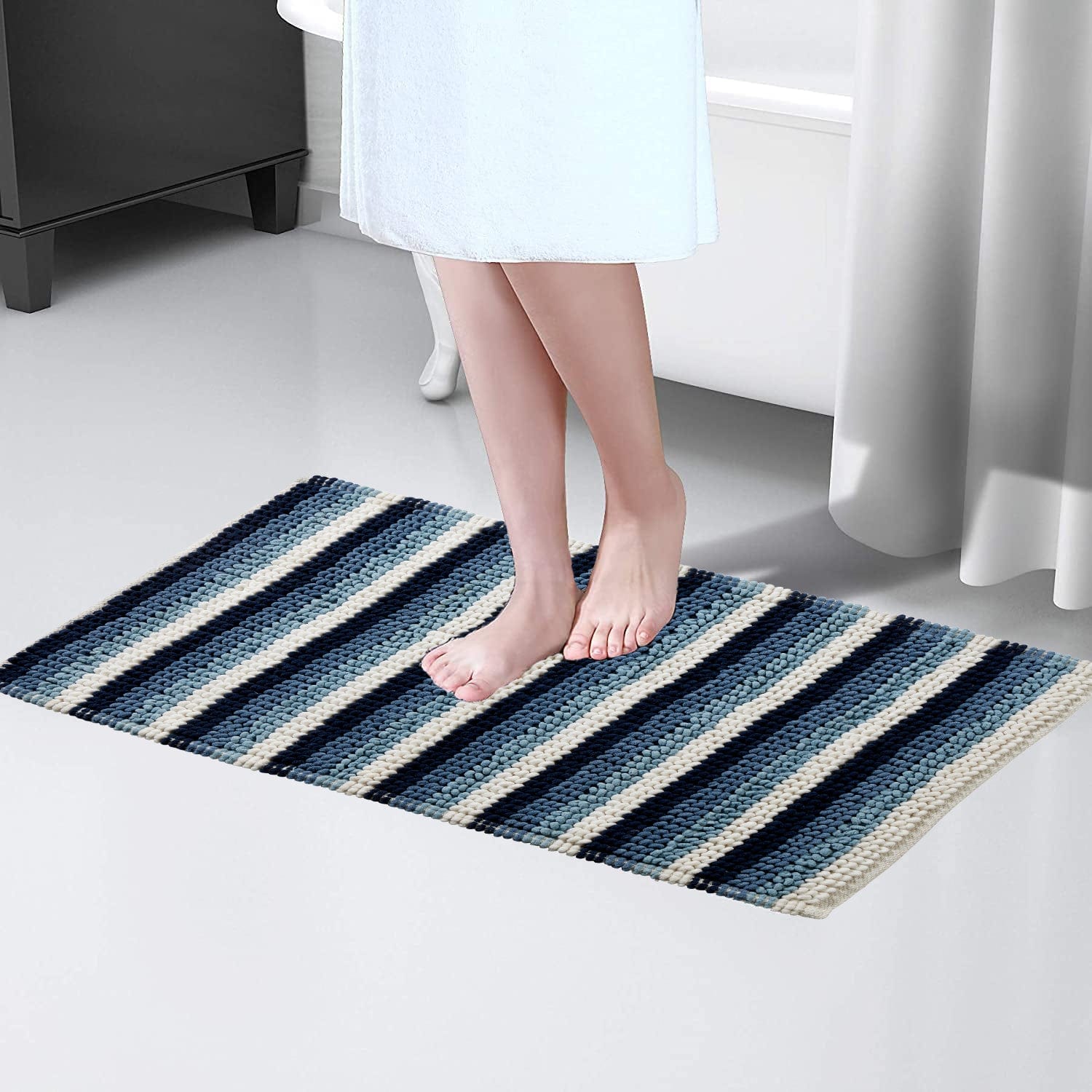 Superior comfort Padstow Stripe Bathmat displayed in a stylish bathroom setting, illustrating its plush soft texture and classic stripe design, tailored for a luxurious experience.