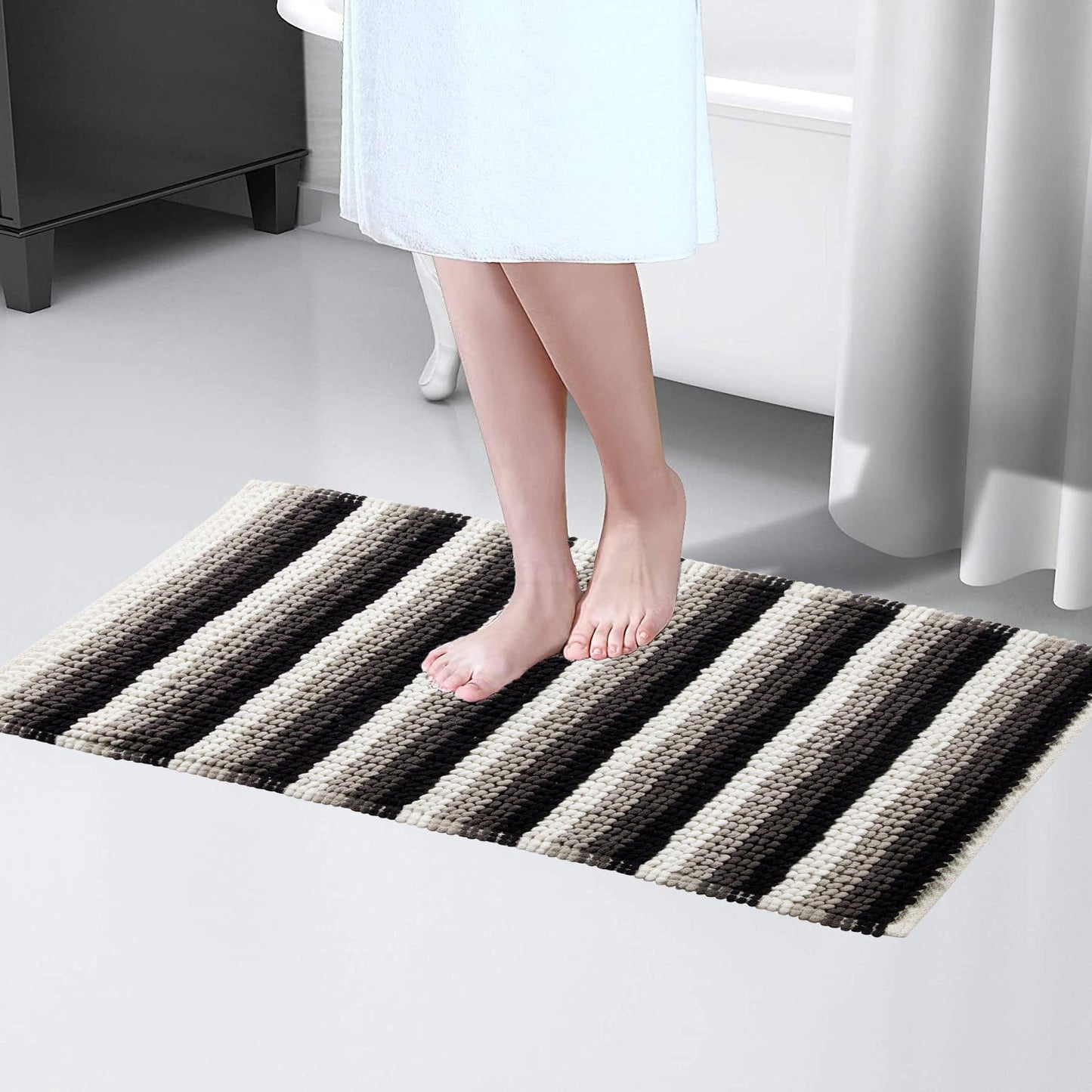 Stylish Padstow Stripe Bathmat displayed in a modern bathroom setting, illustrating its quick-drying features and anti-slip design for safety.