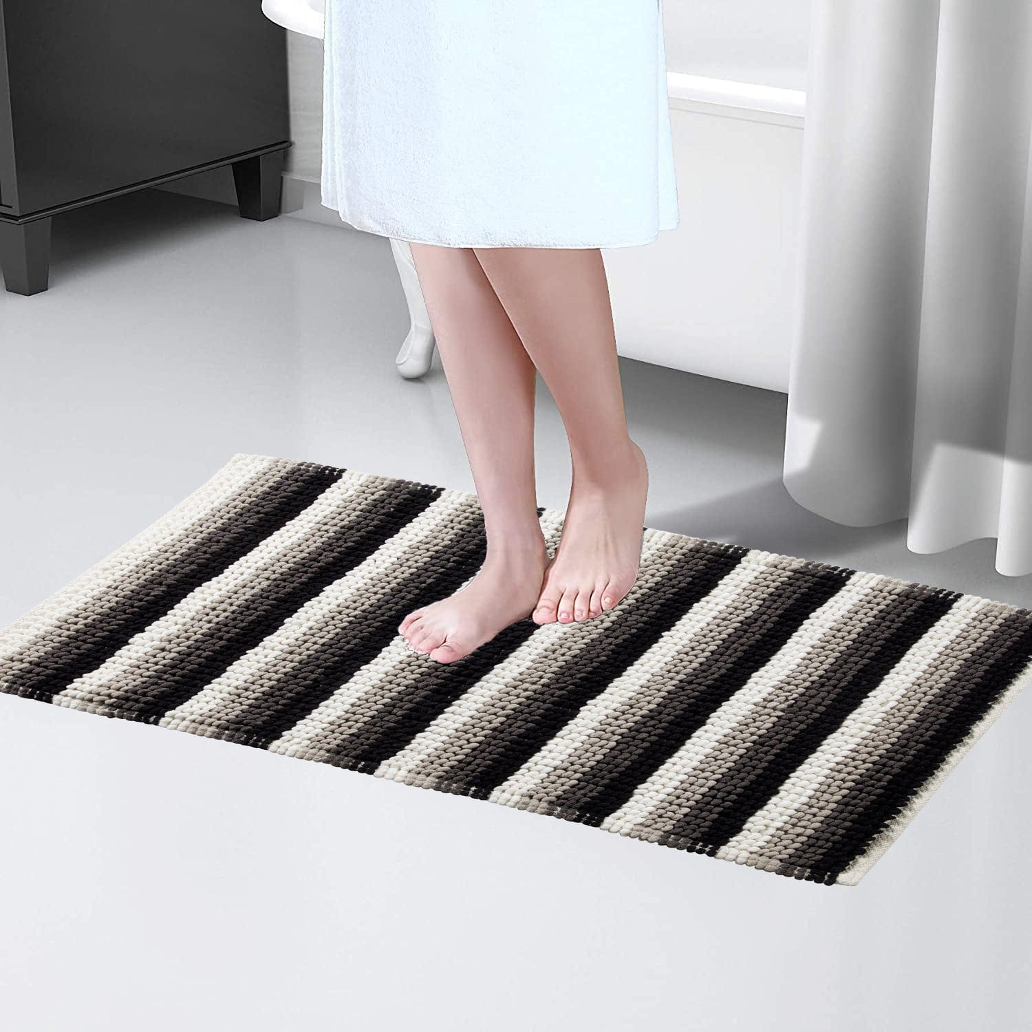 Stylish Padstow Stripe Bathmat displayed in a modern bathroom setting, illustrating its quick-drying features and anti-slip design for safety.