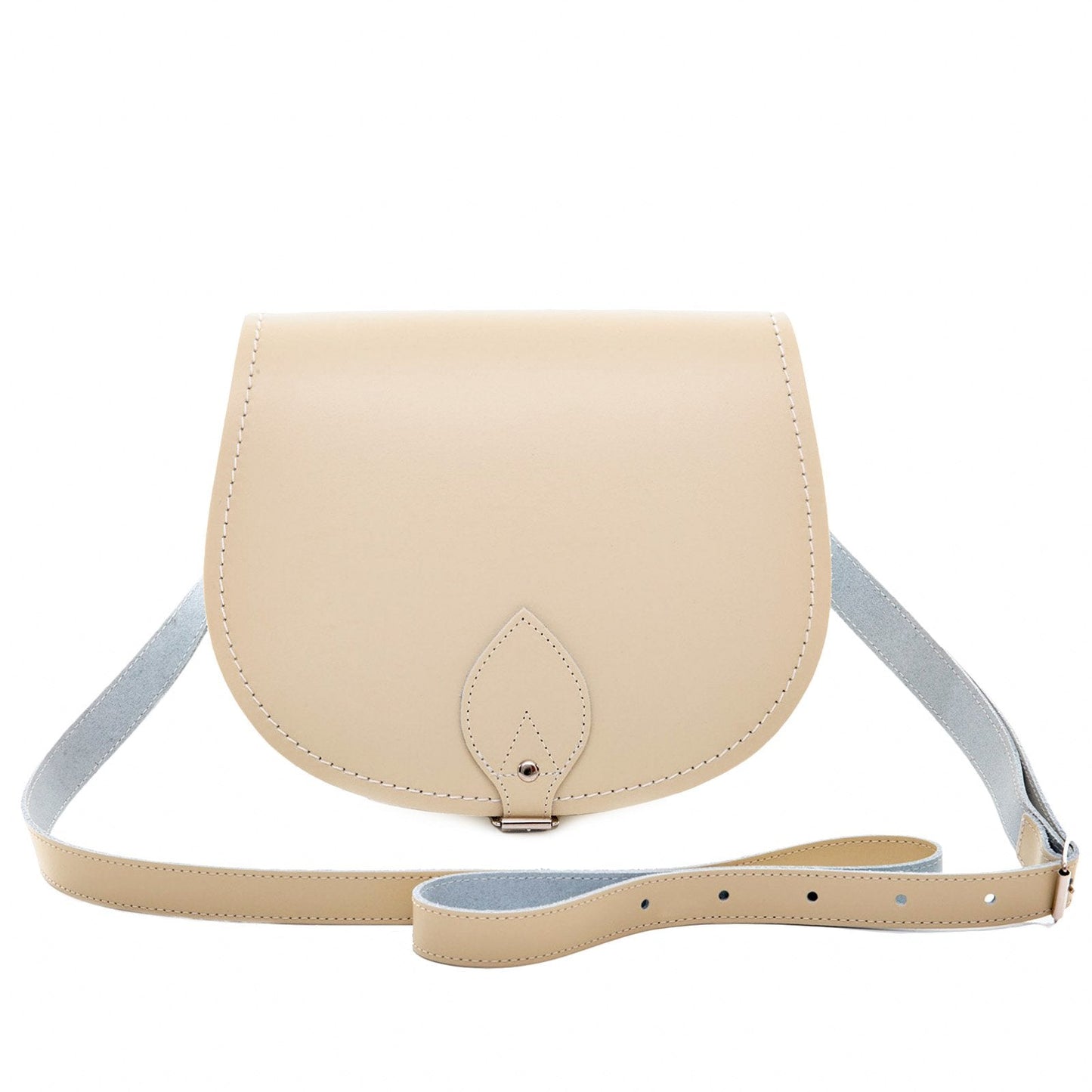 Luxury handmade leather saddle bag in pastel cream featuring adjustable strap and classic buckle, perfect for stylish accessorising.