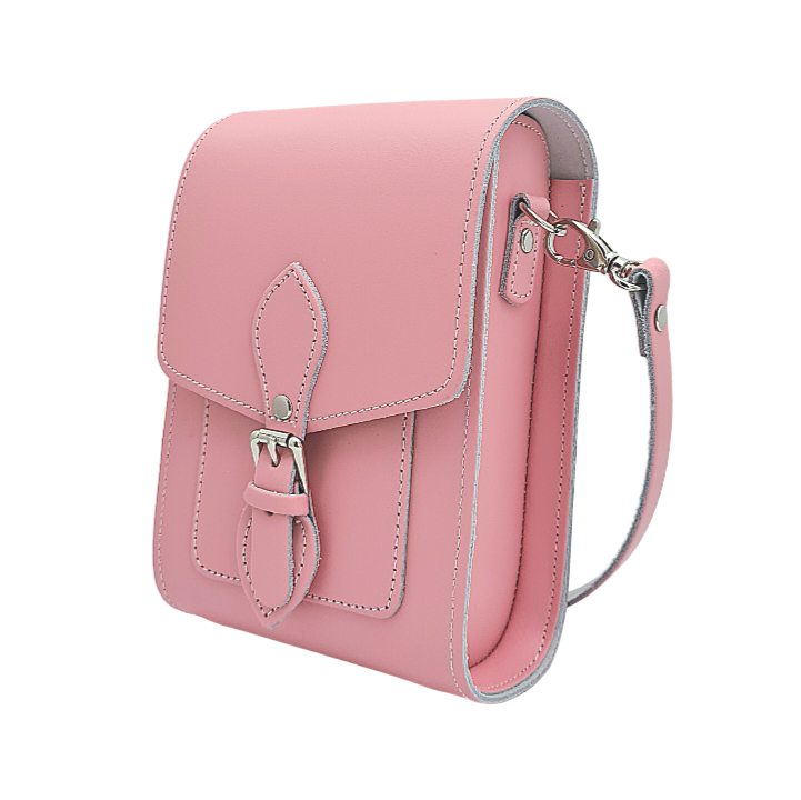 Elegant pastel pink handmade leather festival phone bag with adjustable strap, showcasing premium craftsmanship, ideal for stylish outings, featuring slip-in card pockets and magnetic closure.