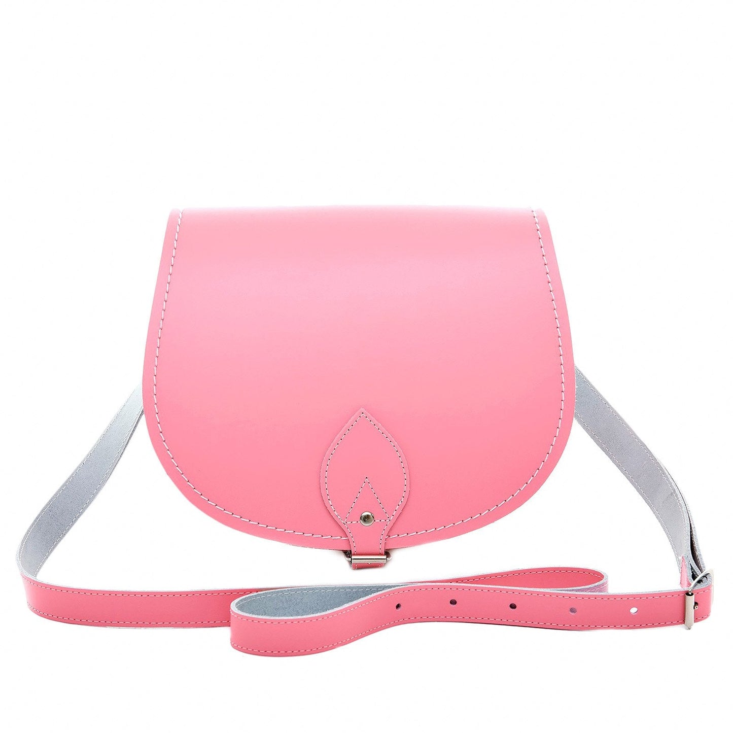 Elegant luxury handmade leather saddle bag in pastel pink with adjustable crossbody strap, showcasing exceptional craftsmanship and timeless design.