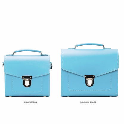 Stylish detail of the secure push lock closure on the Handmade Pastel Baby Blue Leather Sugarcube Handbag, emphasizing both practicality and elegance.