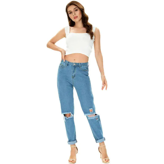 Stylish Plus Size Women's Ripped Jeans accompanied by a chic white crop top, showcasing a modern and trendy casual look.