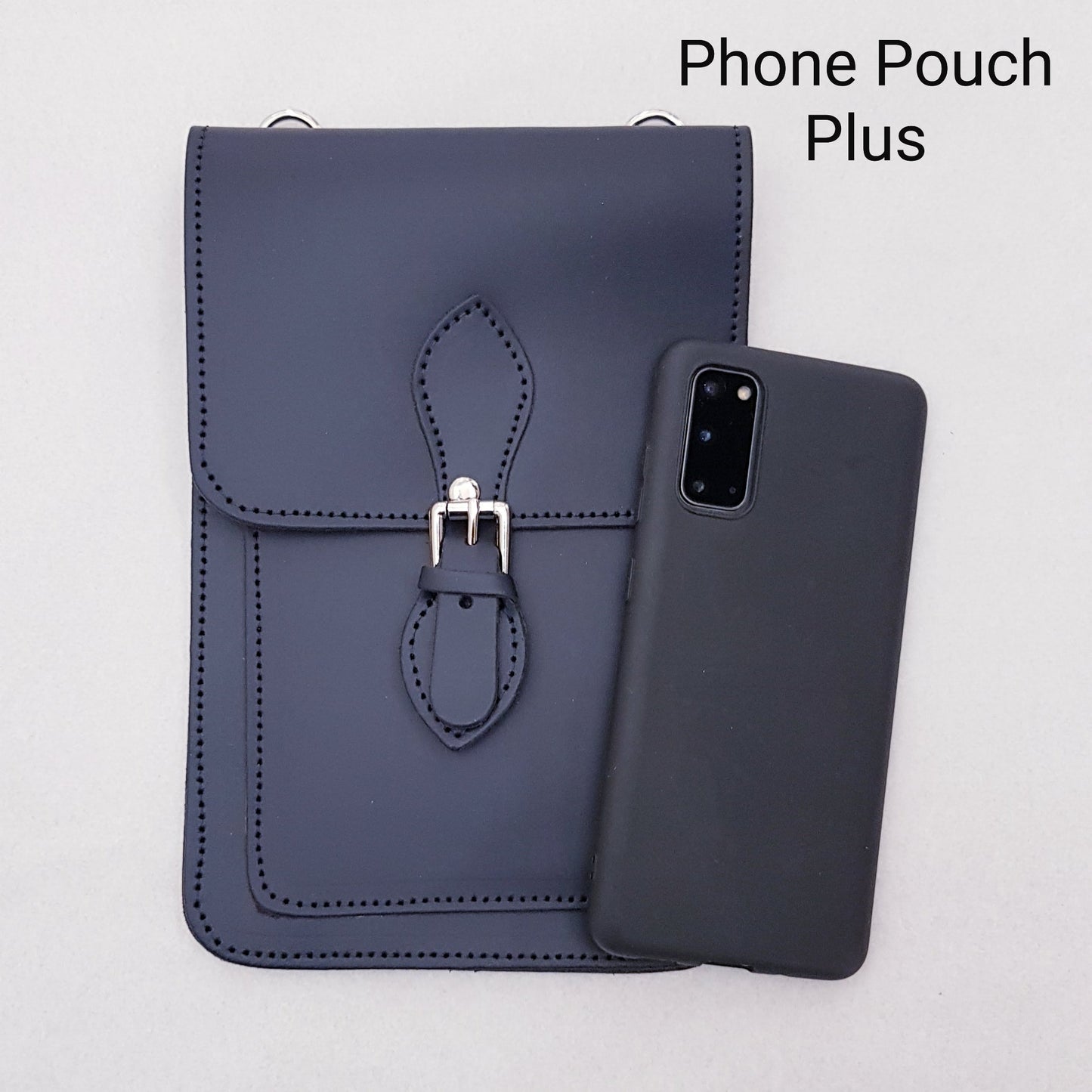 Elegant red leather mobile phone pouch by Zatchels, featuring a secure magnetic fastener and inner pockets for essentials, ideal for both casual and formal occasions.