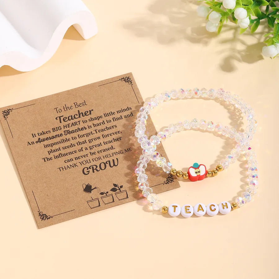 Chic display of the slip-on closure of the 2-piece apple beaded bracelet set, accentuating its ease and style for all occasions.