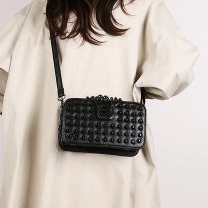 Elegant single shoulder clutch featuring a trendy rivet design, perfect for sophisticated outfits.