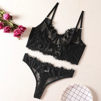 Beautifully styled women's lace lingerie set laid out elegantly, featuring floral patterns and seductive design elements, ideal for special occasions.
