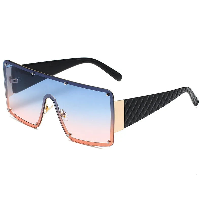 Fashion-forward exaggerated square sunglasses featuring a striking geometric pattern, ideal for glamorous street style.
