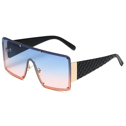 Fashion-forward exaggerated square sunglasses featuring a striking geometric pattern, ideal for glamorous street style.