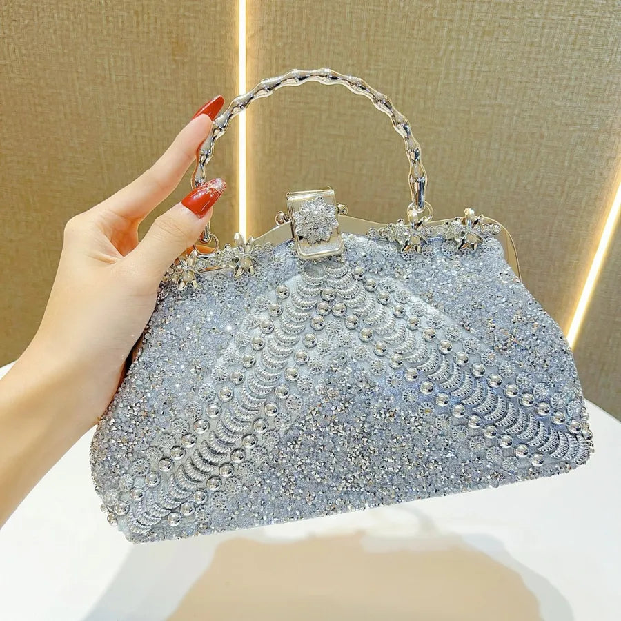 Luxury diamond-studded evening clutch bag in a stylish pillow shape, crafted from elegant PVC material, featuring a chic shoulder strap.
