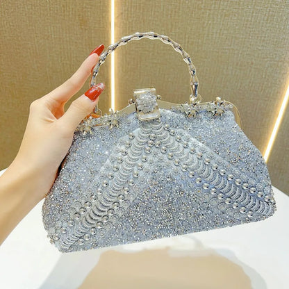 Luxury diamond-studded evening clutch bag in a stylish pillow shape, crafted from elegant PVC material, featuring a chic shoulder strap.