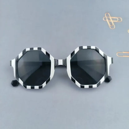 Adorable modern design sunglasses for kids, showcasing a geometric style suitable for outdoor adventures.