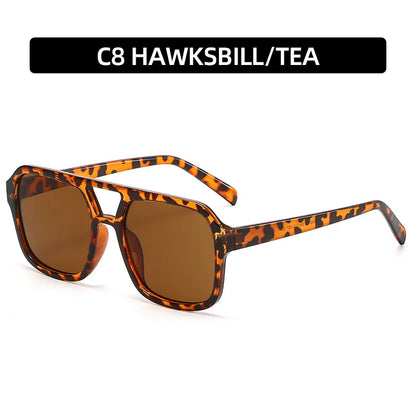Sophisticated women's grey and pink square sunglasses, blending sporty style with elegant design.