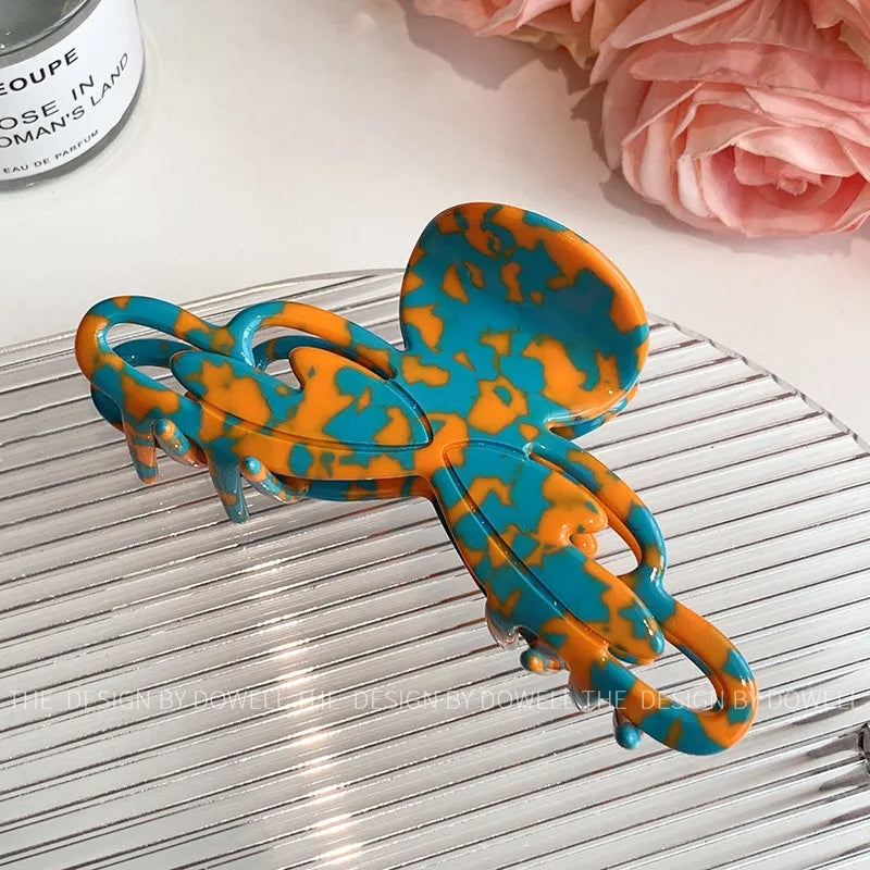 Versatile Elegant Dove Acetate Large Shark Clip demonstrating its stylish function as a headwear accessory for women.